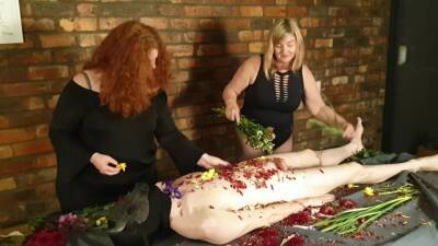 Gorgeous Femdom Duo Flogs Cheating Slave With Flowers on girlsporntube.one