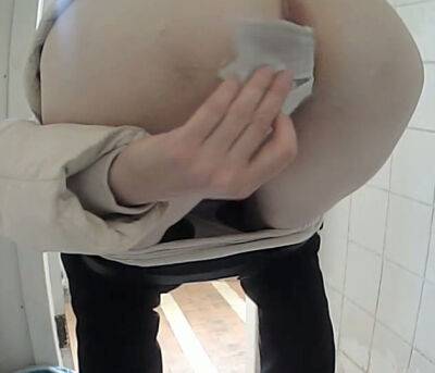 White amateur chick in black pants pissing in the toilet on girlsporntube.one