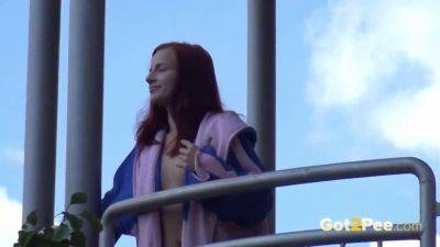 Watch this kinky redhead get a public surprise while peeing in the city on girlsporntube.one