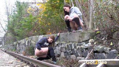 Watch these kinky girls get soaked in pee while getting frisky on the railway on girlsporntube.one