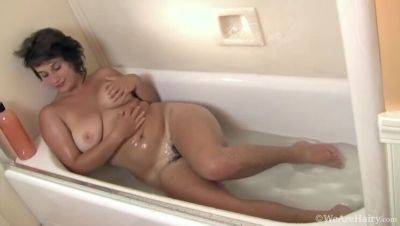 Big-titted brunette, Sayge, indulges in a steamy shower session and soaps up on girlsporntube.one